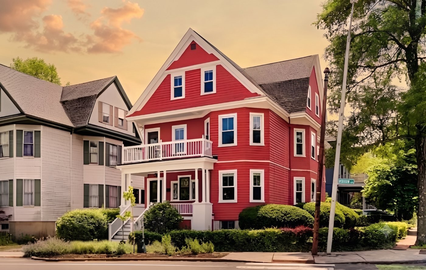 Red multi-family rental house on a tree-lined residential street