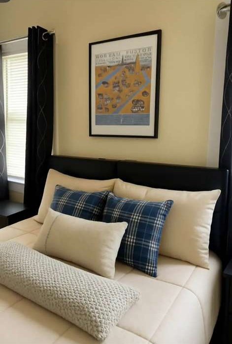 Bedroom with navy checked cushions and a framed map print