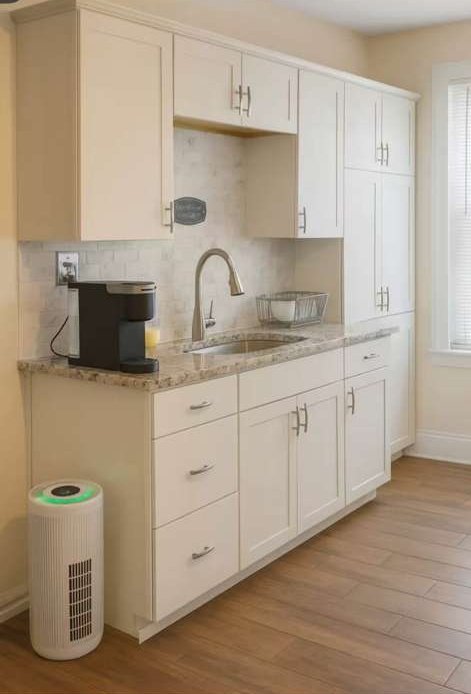 Fitted kitchen with full cabinetry, stone worktops and appliances