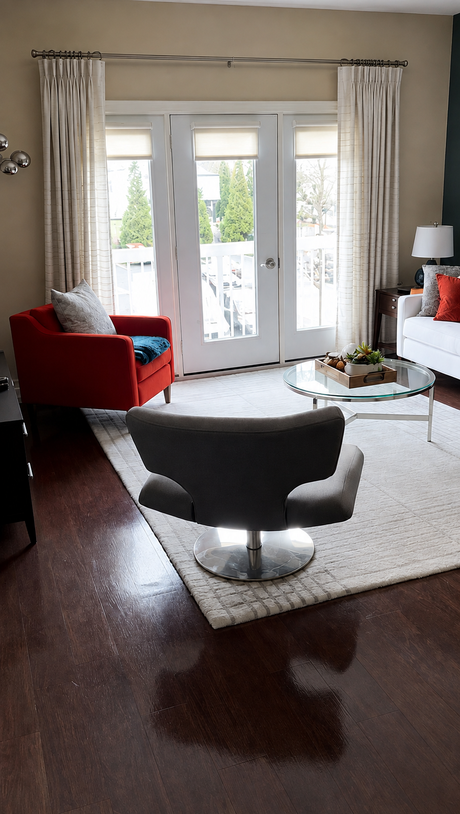 Lounge with a red sofa and lounge chair on dark hardwood flooring